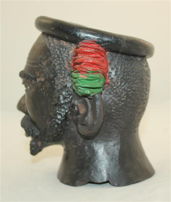 An African painted terracotta jar modelled as the head of a bearded man, 7.5in.